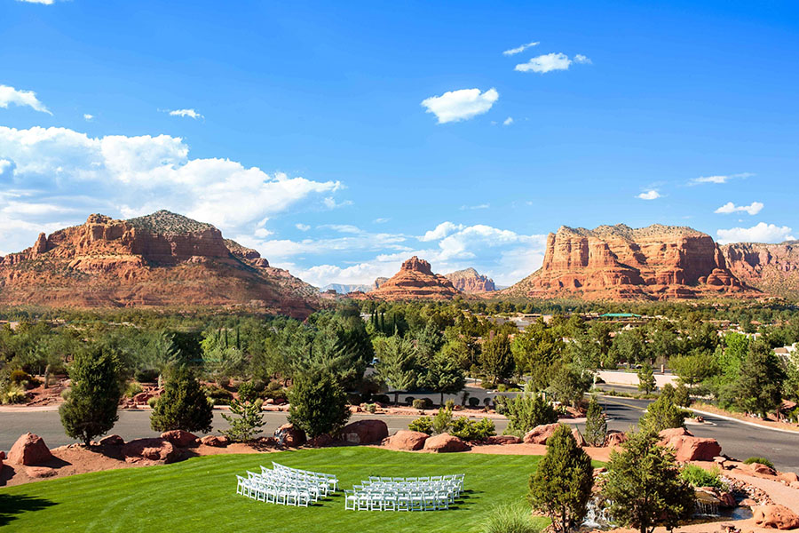 Overhead view of a beautifully arranged ceremony setup at Sedona Golf Resort, showcasing rows of chairs and a stunning backdrop.